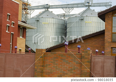 Agricultural Silos. Building Exterior. Storage and drying of grains, wheat, corn, soy, sunflower Agricultural Silos. Building Exterior. Storage and drying of grains, wheat, corn, soy, sunflower 98018035