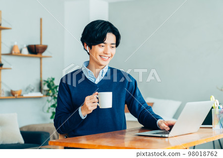 Teleworking young man Teleworking young man 98018762