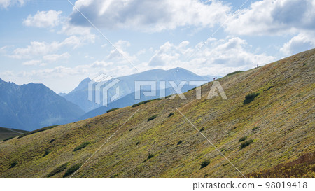 Hikers in distance walking the ridge in alpine environment, Slovakia, Europe 98019418