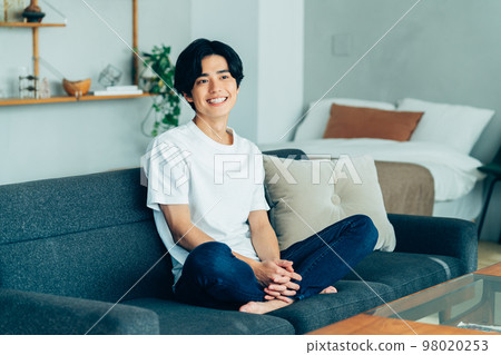 Young man relaxing in the room Young man relaxing in the room 98020253