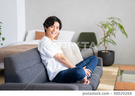 Young man relaxing in the room 98020268