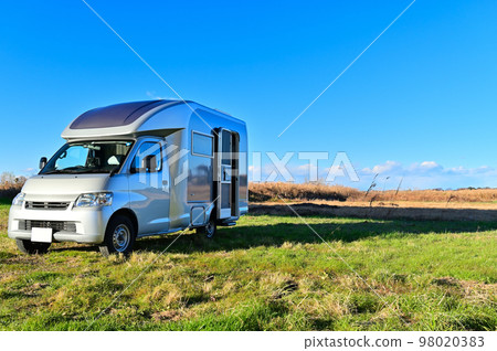 A refreshing blue sky and a camper A refreshing blue sky and a camper 98020383