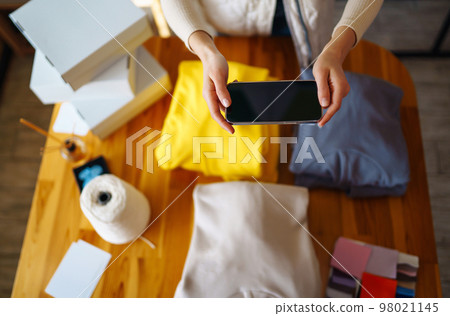 Small business owner, entrepreneur, seller using tablet checking ecommerce clothing store orders. Small business owner, entrepreneur, seller using tablet checking ecommerce clothing store orders. 98021145