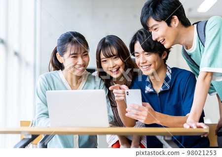 Male and female college students looking at a computer Male and female college students looking at a computer 98021253