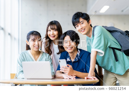 Male and female college students looking at a computer Male and female college students looking at a computer 98021254