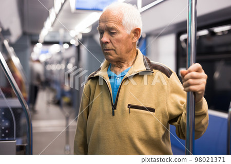 Portrait of man traveling in subway train during daily Portrait of man traveling in subway train during daily 98021371