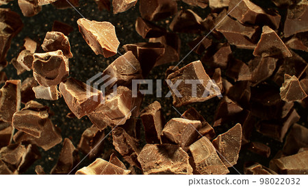 Freeze motion of flying group of raw chocolate pieces. Freeze motion of flying group of raw chocolate pieces. 98022032