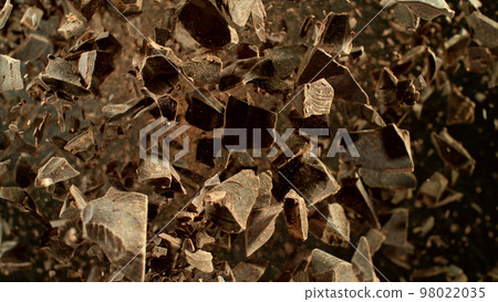 Freeze motion of flying group of raw chocolate pieces. Freeze motion of flying group of raw chocolate pieces. 98022035