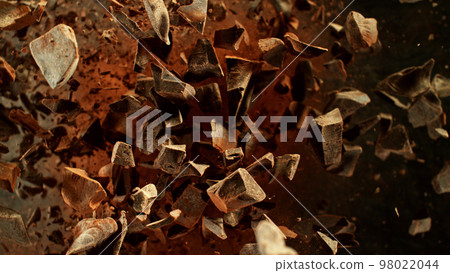 Freeze motion of flying group of raw chocolate pieces. 98022044