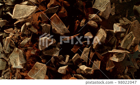 Freeze motion of flying group of raw chocolate pieces. Freeze motion of flying group of raw chocolate pieces. 98022047