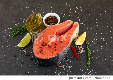 Salmon steak on black Salmon steak on black 98023545