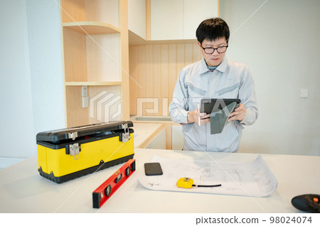 Interior manual worker working with construction tools Interior manual worker working with construction tools 98024074