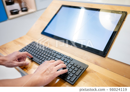 Male hand typing on computer keyboard Male hand typing on computer keyboard 98024119