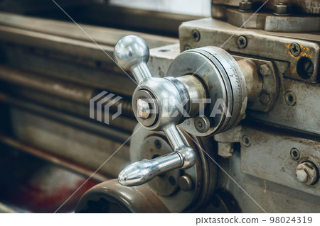 Old lathe for metal processing. Type of metal machine parts in lathe shop at factory. Industrial 98024319