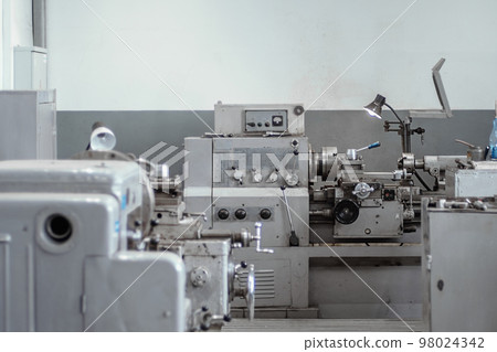 Old lathe for metal processing. Type of metal machine parts in lathe shop at factory. Industrial 98024342