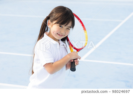 kid playing tennis kid playing tennis 98024697
