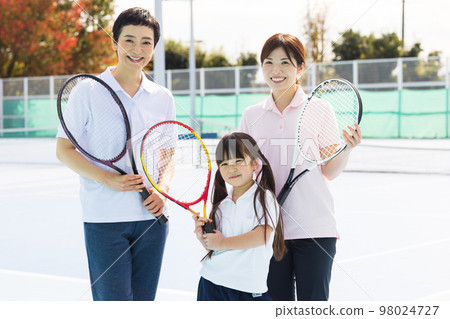 A woman enjoying tennis A woman enjoying tennis 98024727