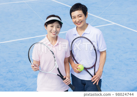 A woman enjoying tennis A woman enjoying tennis 98024744