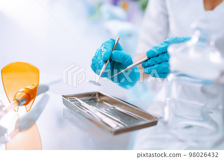 A set of sterile dental instruments for dental treatment. Dental care for people. 98026432