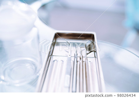 A set of sterile dental instruments for dental treatment. Dental care for people. A set of sterile dental instruments for dental treatment. Dental care for people. 98026434