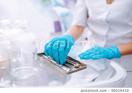 A set of sterile dental instruments for dental treatment. Dental care for people. 98026438