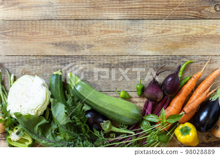 Organic vegetables for healthy cooking background. Fall harvest. The concept of vegan or diet food. Various vegetables on a rustic kitchen table. View from above. Copy space. Organic vegetables for healthy cooking background. Fall harvest. The concept of vegan or diet food. Various vegetables on a rustic kitchen table. View from above. Copy space. 98028889