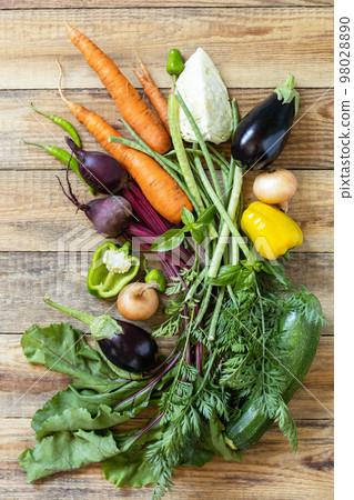 Organic vegetables for healthy cooking background. Fall harvest. The concept of vegan or diet food. Various vegetables on a rustic kitchen table. Organic vegetables for healthy cooking background. Fall harvest. The concept of vegan or diet food. Various vegetables on a rustic kitchen table. 98028890