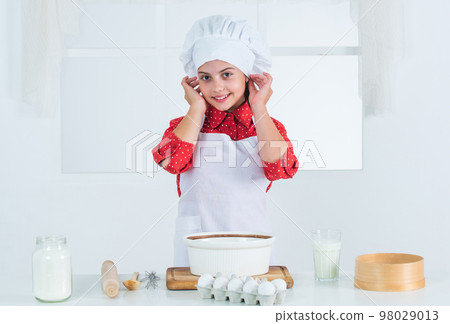 cheerful child girl cooking home pastry, dough cheerful child girl cooking home pastry, dough 98029013