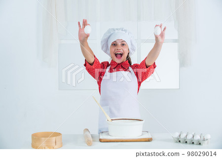 happy girl hold eggs for dough, bakery happy girl hold eggs for dough, bakery 98029014