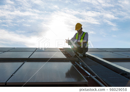 Engineer working setup Solar panel at the roof top.  98029058
