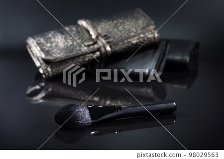 Black brush for a make-up on a black background. Cosmetic set 98029563