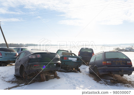 Disassembled cars on a car dump are on sale for spare parts. Disassembled cars on a car dump are on sale for spare parts. 98030007