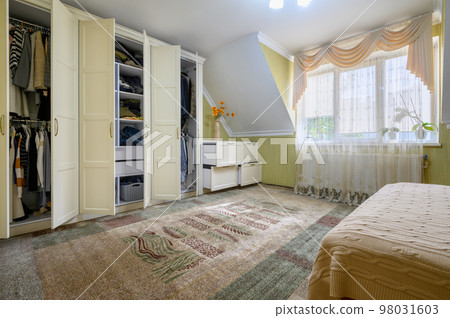 Interior of a large comfortable bedroom with double bed Interior of a large comfortable bedroom with double bed 98031603