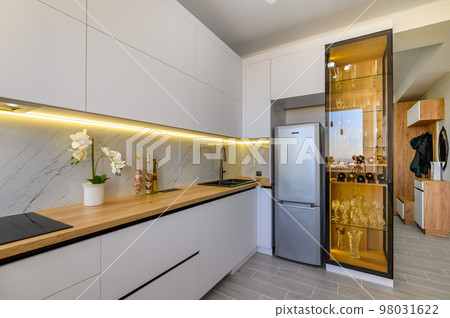 A modern white studio with a stylish kitchen A modern white studio with a stylish kitchen 98031622