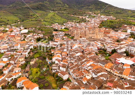 Drone view of Guadalupe with residential buildings and medieval Monastery 98033248