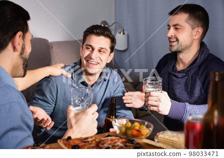 Friendly meeting in men company over beer with pizza 98033471