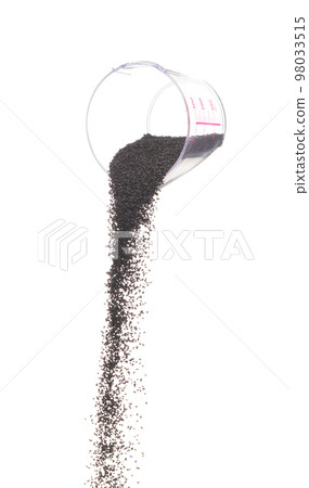 Black Sesame pouring down from measure cup, black Sesame grain wave floating, fall in air. Basil seed is organic healthy food. White background Isolated high speed shutter, freeze stop motion 98033515