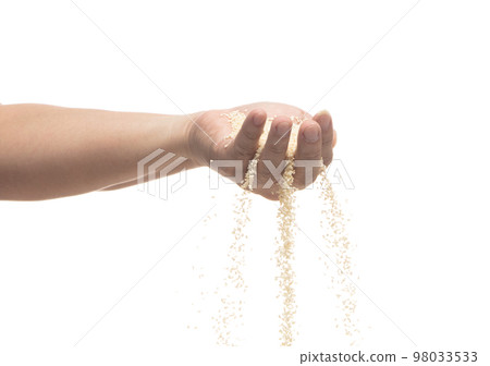 White Sesame pouring down from hand fingers, white Sesame grain wave floating, fall in air. Basil seed is organic healthy food. White background Isolated high speed shutter, freeze stop motion 98033533