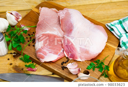 Fresh raw pork secreto fillet (Secreto de cerdo) and condiments prepared for roasting Fresh raw pork secreto fillet (Secreto de cerdo) and condiments prepared for roasting 98033623