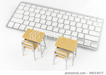 A study desk with a keyboard and a toy. An image of a computer classroom 98033677