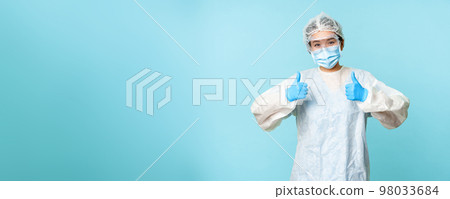 Optimistic asian nurse or doctor, wearing personal protective equipment, showing thumbs up, campaign from coronavirus prevention, blue background Optimistic asian nurse or doctor, wearing personal protective equipment, showing thumbs up, campaign from coronavirus prevention, blue background 98033684