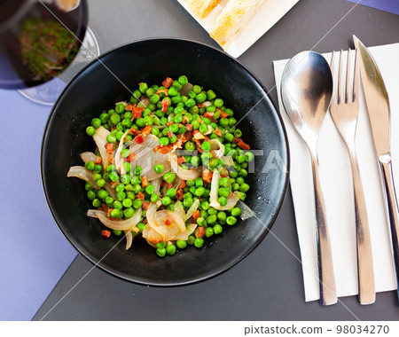 Appetizing dish of peas with ham 98034270
