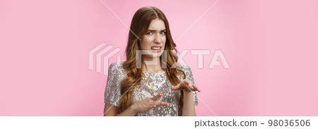 Disgusted reluctant young arrogant glamour woman telling about creepy man cringing aversion grimacing dislike gesturing displeased, expressing antipathy standing pink background freaked-out Disgusted reluctant young arrogant glamour woman telling about creepy man cringing aversion grimacing dislike gesturing displeased, expressing antipathy standing pink background freaked-out 98036506