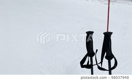 Ski poles on the slopes 98037948
