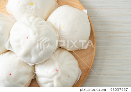 stuffed steamed bun on wood plate stuffed steamed bun on wood plate 98037967