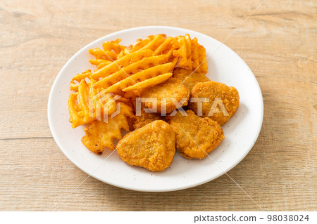 fried chicken nuggets with fried potatoes fried chicken nuggets with fried potatoes 98038024