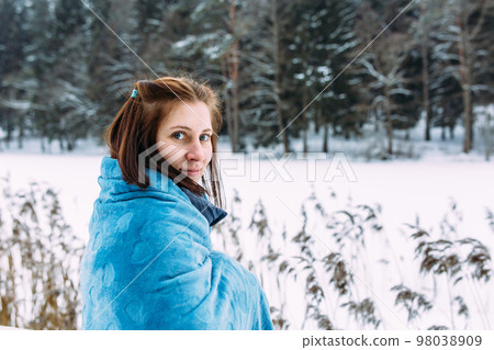 portrait of woman in winter clothes on the nature. There is a lot of snow around portrait of woman in winter clothes on the nature. There is a lot of snow around 98038909