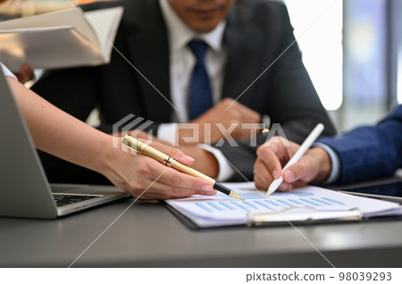 Professional financial Analysts team having a formal meeting. pen pointing on paper. close-up 98039293