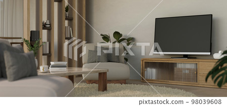 Cozy Scandinavian living room with TV on minimal wood TV cabinet, comfortable couch and decor 98039608
