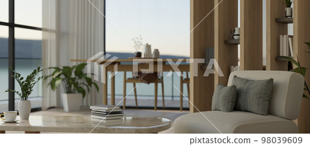 Luxury and cozy living room with balcony interior design with couch, coffee table, dining table 98039609